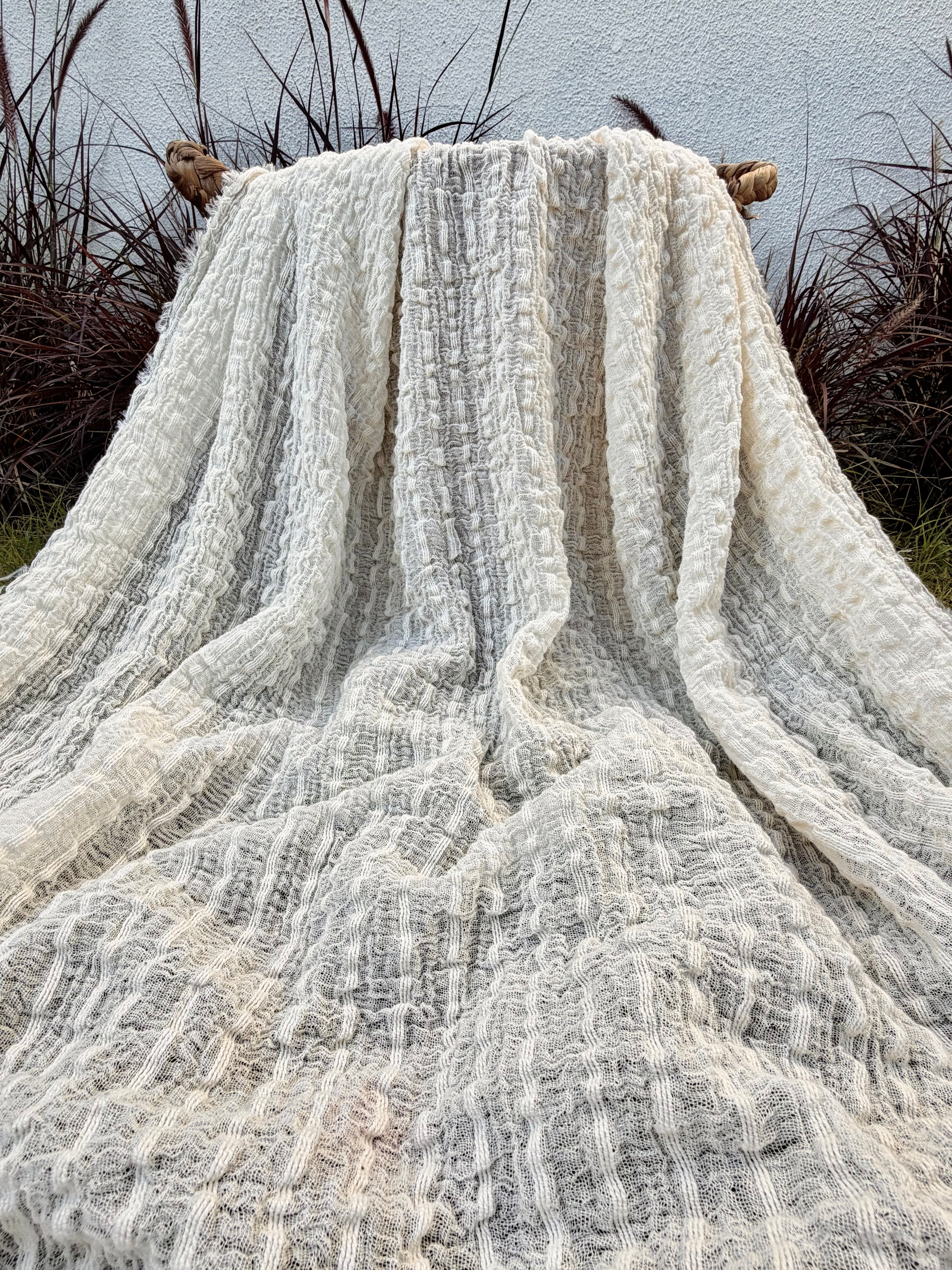Tissu en coton froissé extensible neutre, surface texturée, coton tissé à la main blanc cassé, coton beige biologique semi-transparent et non blanchi.