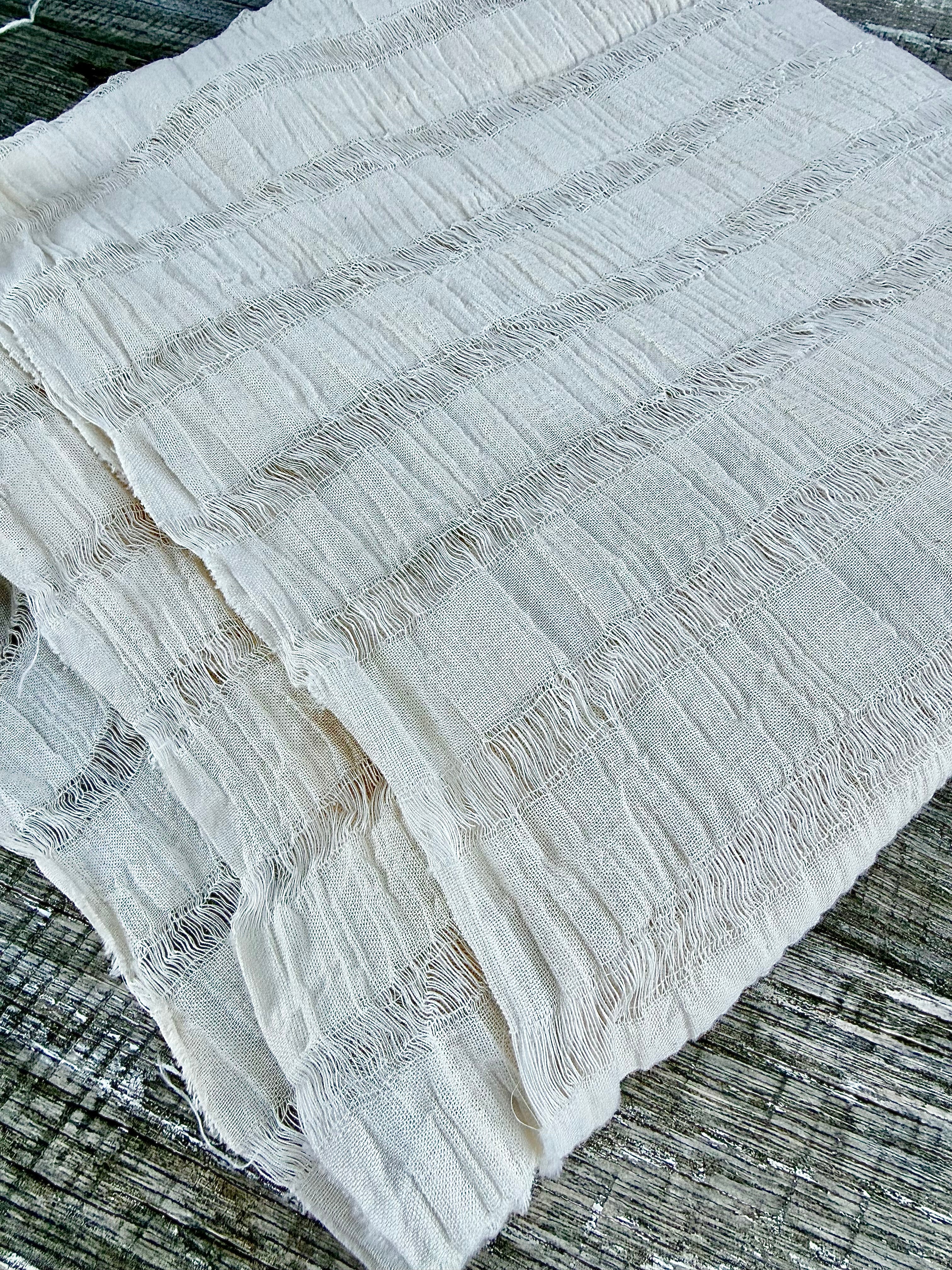 Tissu en coton froissé extensible neutre, surface texturée, coton tissé à la main blanc cassé, coton beige biologique semi-transparent et non blanchi.